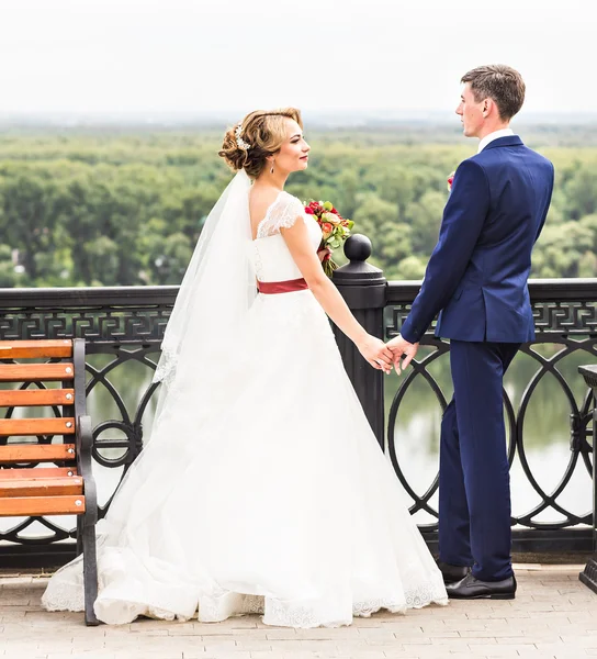 Gelin ve damat dışarıda el ele tutuşuyorlar..