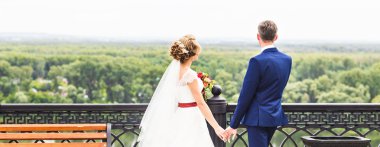 Düğün teması, el ele tutuşmalar, yeni evliler.