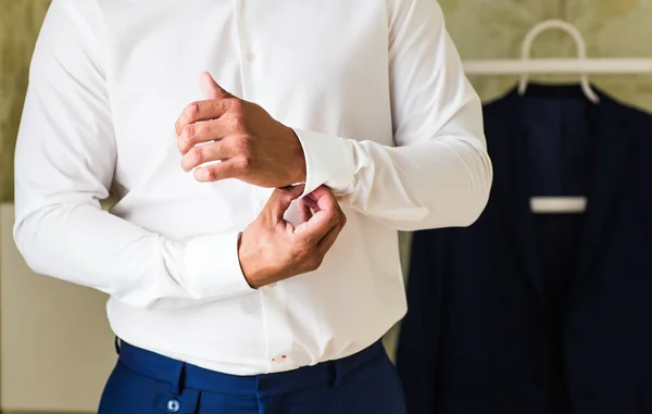 Business man fastening buttons on shirt sleeve at home close-up — Stock Photo, Image