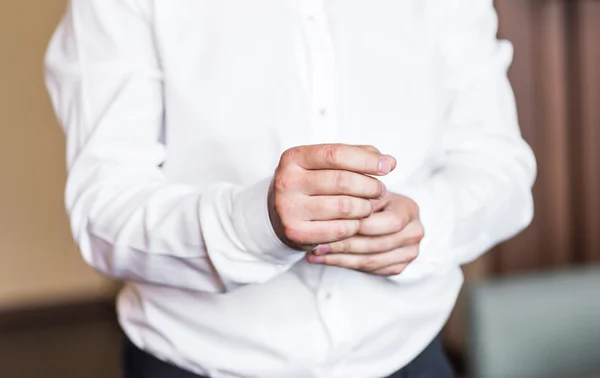 Business man fastening buttons on shirt sleeve at home close-up — Stock Photo, Image