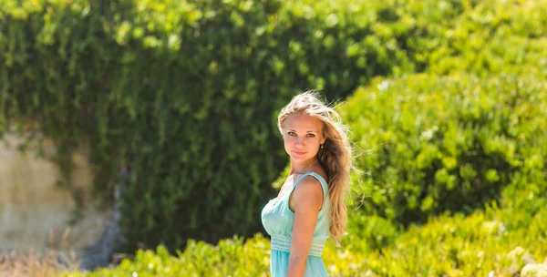 Portrait of blond woman in mint-colored dress outdoor — Stock Photo, Image
