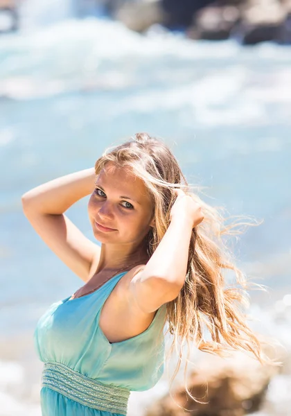 Beautiful young blond woman outdoors portrait near the sea or ocean — Stock Photo, Image