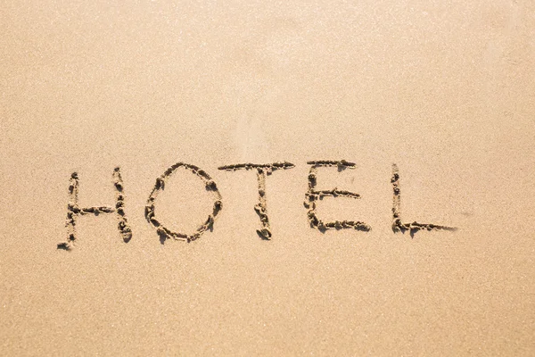 Parola HOTEL sulla sabbia — Foto Stock