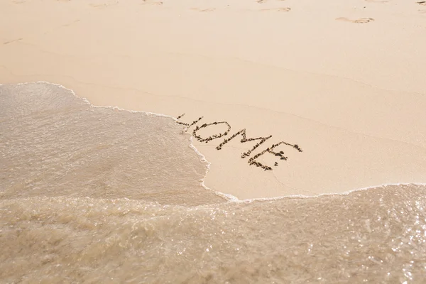 Word home written in sand on beach — Stock Photo, Image