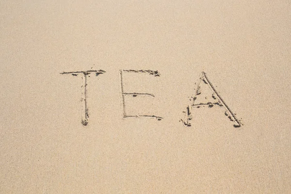 ビーチで砂で書かれて単語のお茶 — ストック写真