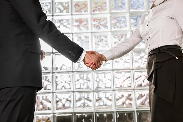 Business handshake. Businessman And Businesswoman Shaking Hands In Office — Stock Photo, Image