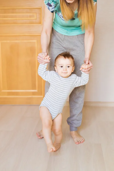 Mother and baby legs. First steps.