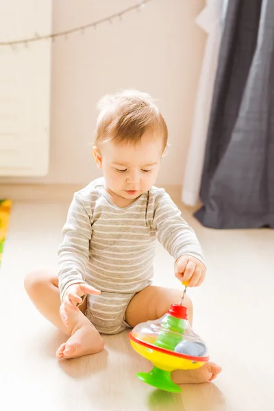Baby boy playing with toy indoors at home — Stock Photo, Image