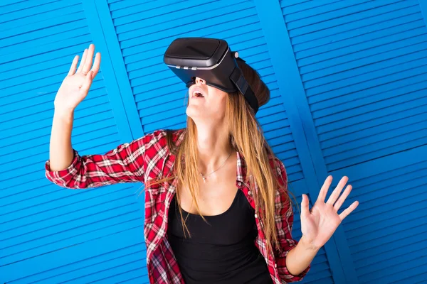 Happy woman getting experience using VR-headset glasses of virtual reality much gesticulating hands — Stock Photo, Image
