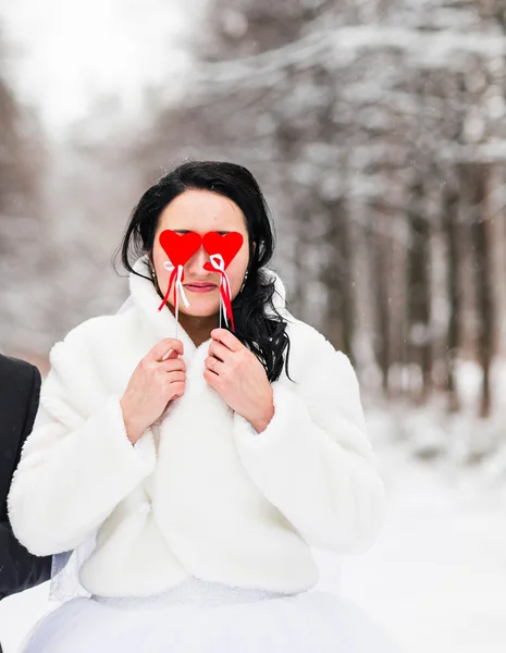 Braut hält Papierherzen im Winterpark — Stockfoto