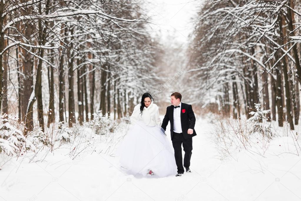 Happy bride and groom in winter wedding day
