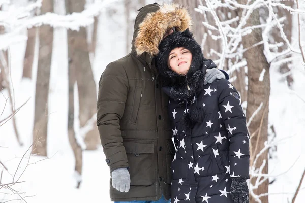 Divertimento, estação e conceito de lazer - casal amor joga madeira de inverno na neve — Fotografia de Stock