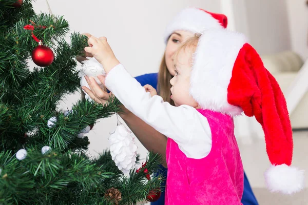 Koncepcja Bożego Narodzenia - matka i jej córeczka z choinką w salonie — Zdjęcie stockowe