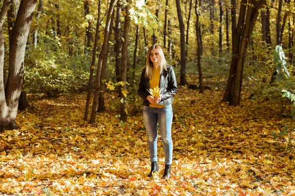 Портрет красивой женщины держит осенние листья. Стильная молодость и концепция осеннего сезона. — стоковое фото