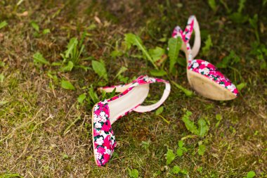 Pink shoes on the grass clipart