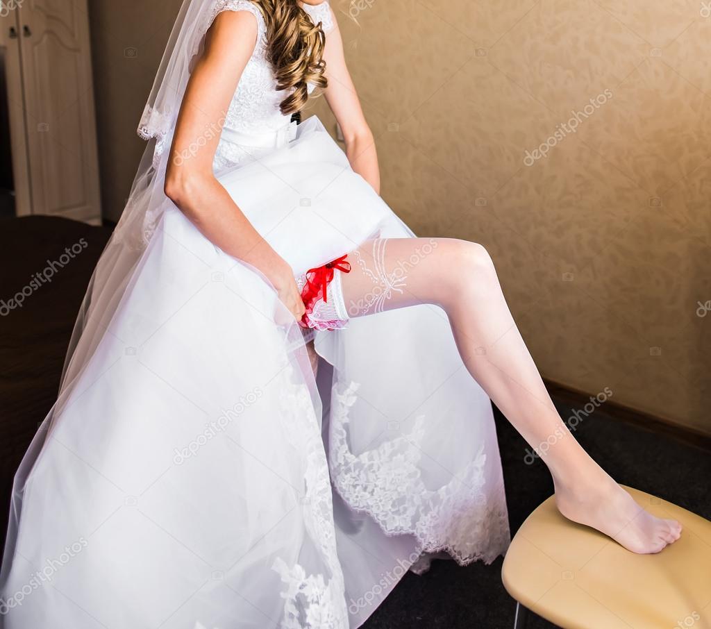 Bride dresses garter on the — Stock Photo © Satura_ #78472644