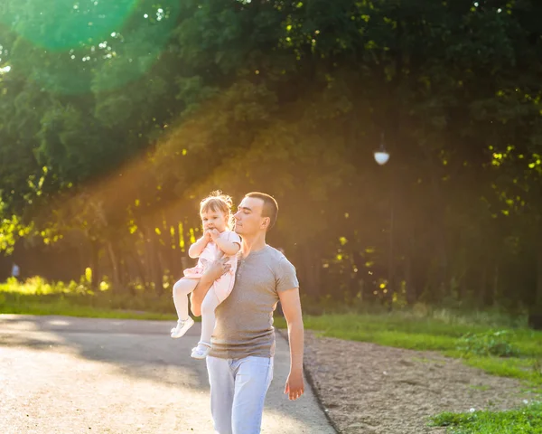 Bébé fille marche dans un parc d'été avec son père — Photo