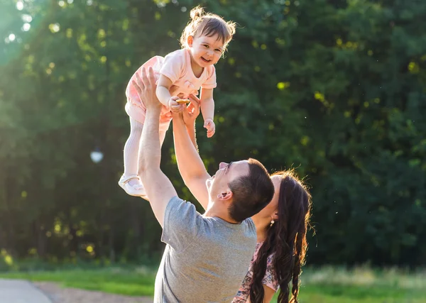 Joyeux jeune famille marchant dans le parc. — Photo