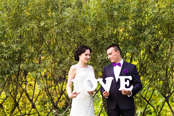 Bride and groom with  word — Stock Photo, Image