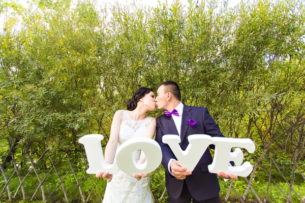 Bride and groom with  word — Stock Photo, Image