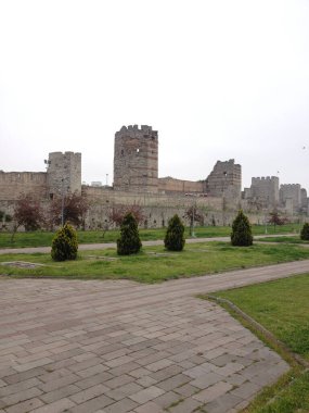 İstanbul 'un eski taş duvarları yeşilliklerle çevrili. Hafıza, dayanıklılık ve geçmiş ve şimdiki zaman arasındaki katmanlı bağlantı