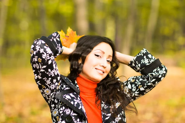 Niedliches Mädchen mit gelben Ahornblättern in der Hand — Stockfoto