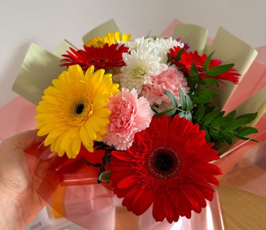 Close up view of a colorful flower bouquet with fresh blooms. Floral beauty, celebration mood, aesthetic pleasure, emotional warmth, gift symbolism, tenderness, and attention expressed through natural details.