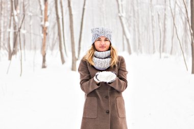 Kız parkta karla oynuyor