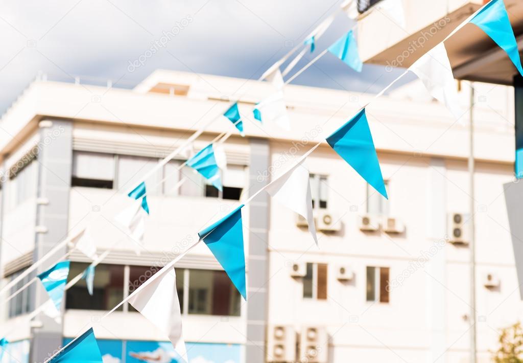 Small triangular waving flags in city