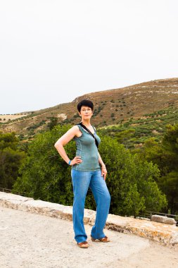 happy woman posing against a background of mountain