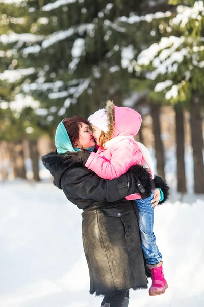 Família feliz mãe e bebê filhinha brincando no parque de inverno. Férias de Natal — Fotografia de Stock