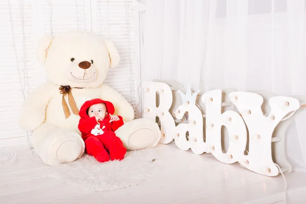 Baby with teddy bear. Christmas holiday concept