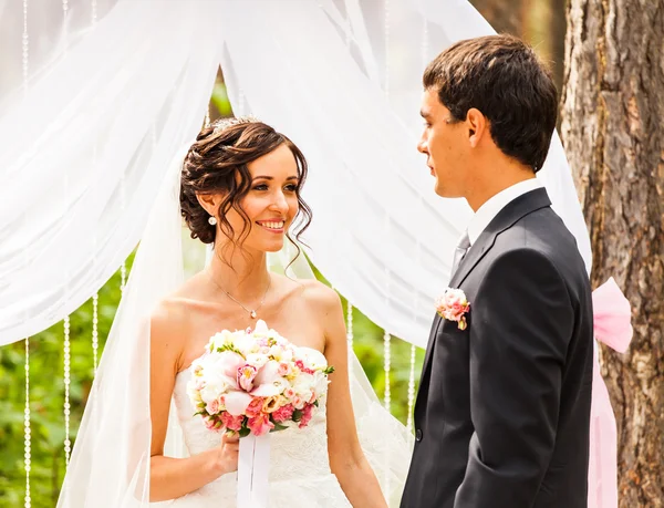 Couple Getting Married at an Outdoor Wedding Ceremony Stock Photo