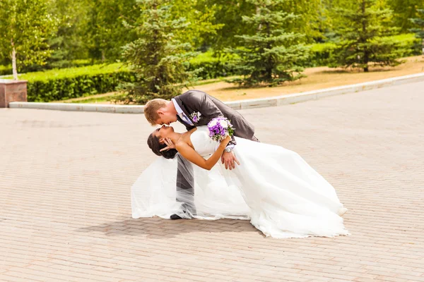 Bräutigam hält Braut am Hochzeitstag in Tanzpose — Stockfoto