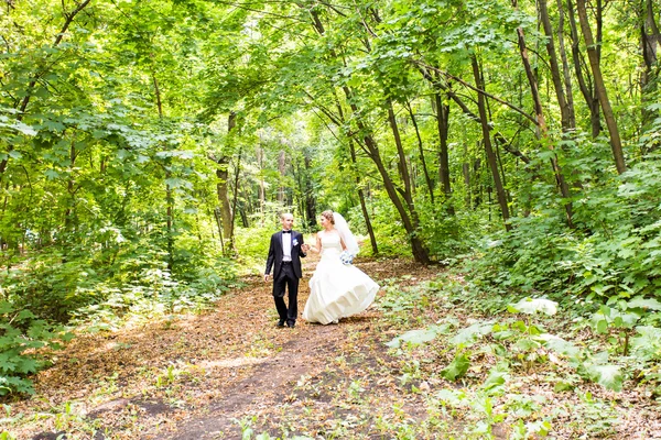 Bride and Groom at wedding Day walking Outdoors