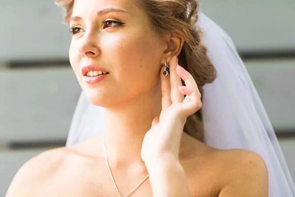 Close up of beautiful woman wearing shiny diamond earrings — Stock Photo, Image