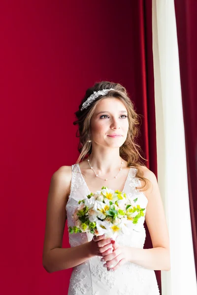 Bela noiva jovem com maquiagem de casamento e penteado no quarto — Fotografia de Stock