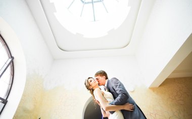 Çift tutuşup düğün ve kucaklayan.