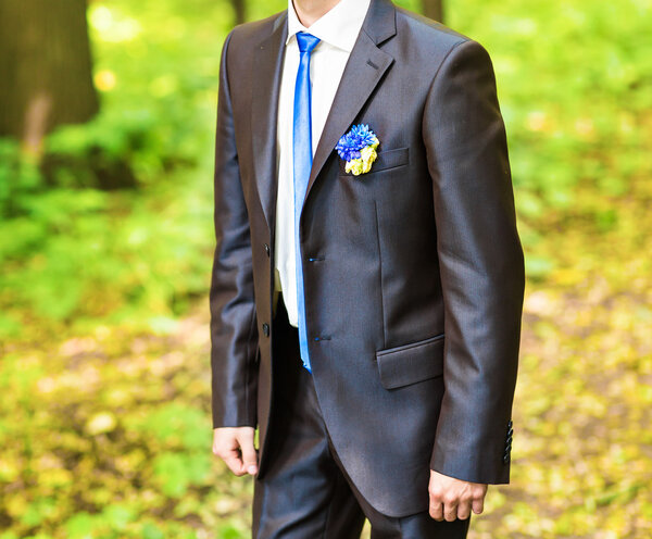 groom in a park on their wedding day.