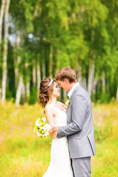 Bruden och brudgummen på bröllop dag promenader utomhus på vår natur. — Stockfoto