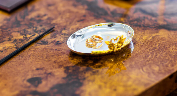 wedding rings on a silver plate