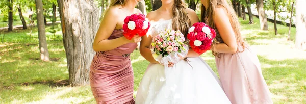 Bride and bridesmaids near trees — Stock Photo, Image