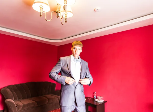 Adult groom button his  suit — Stock Photo, Image