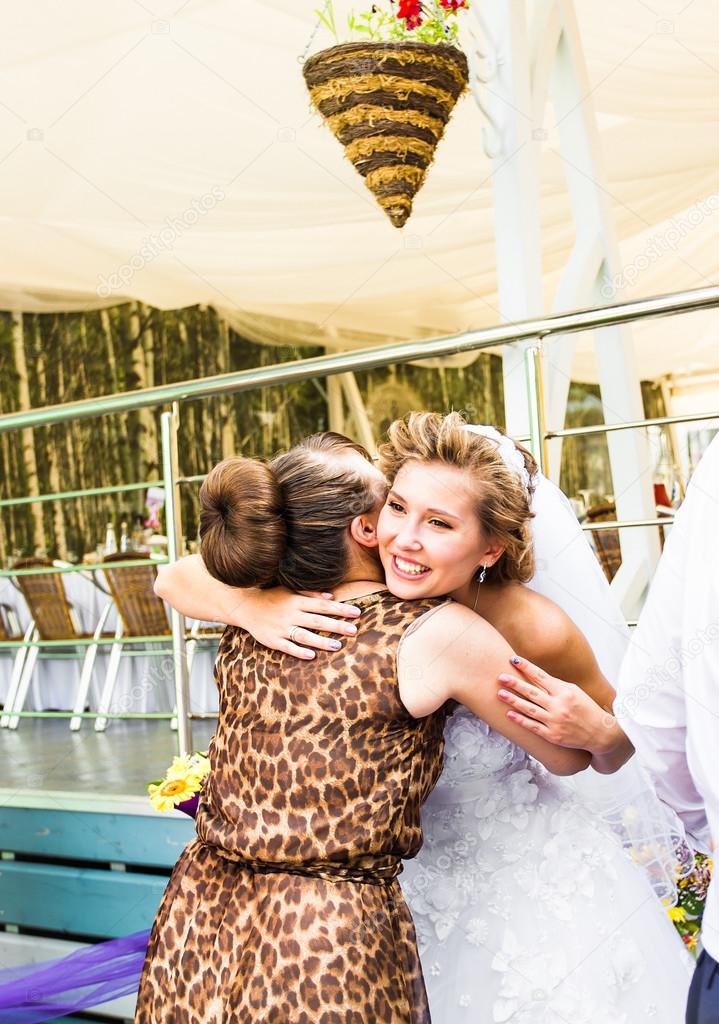 Bride Hugging Sister On Wedding Day