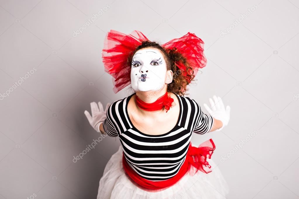 Portrait of the woman as mime sending a kiss. Concept of love and april fools day