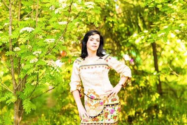 Schöne Frau, die im Frühling oder Sommer im Park steht — Stockfoto