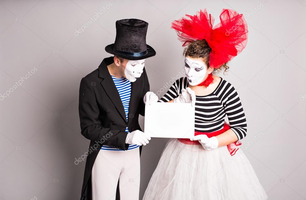 Two mimes   with a sign for advertising, April Fools Day concept