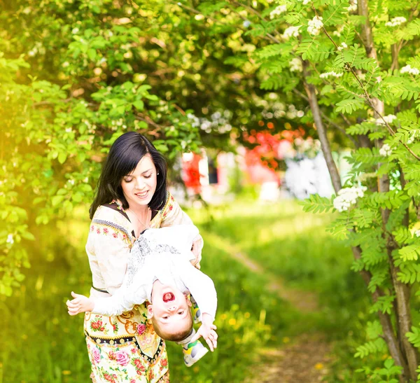 Glückliche Familie, Freunde für immer. Lächelnde Mutter und kleiner Sohn beim gemeinsamen Spielen in einem Park. Mutter hält lachendes Baby. Muttertag — Stockfoto
