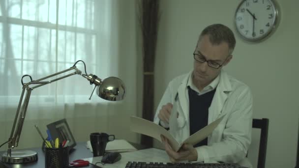 Onun ofis masasında bir tıp doktoru — Stok video