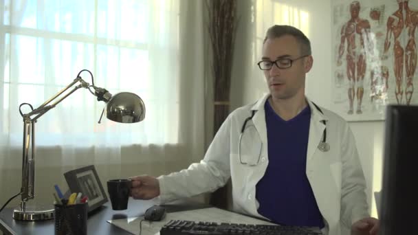 Un doctor lucrează la biroul său — Videoclip de stoc